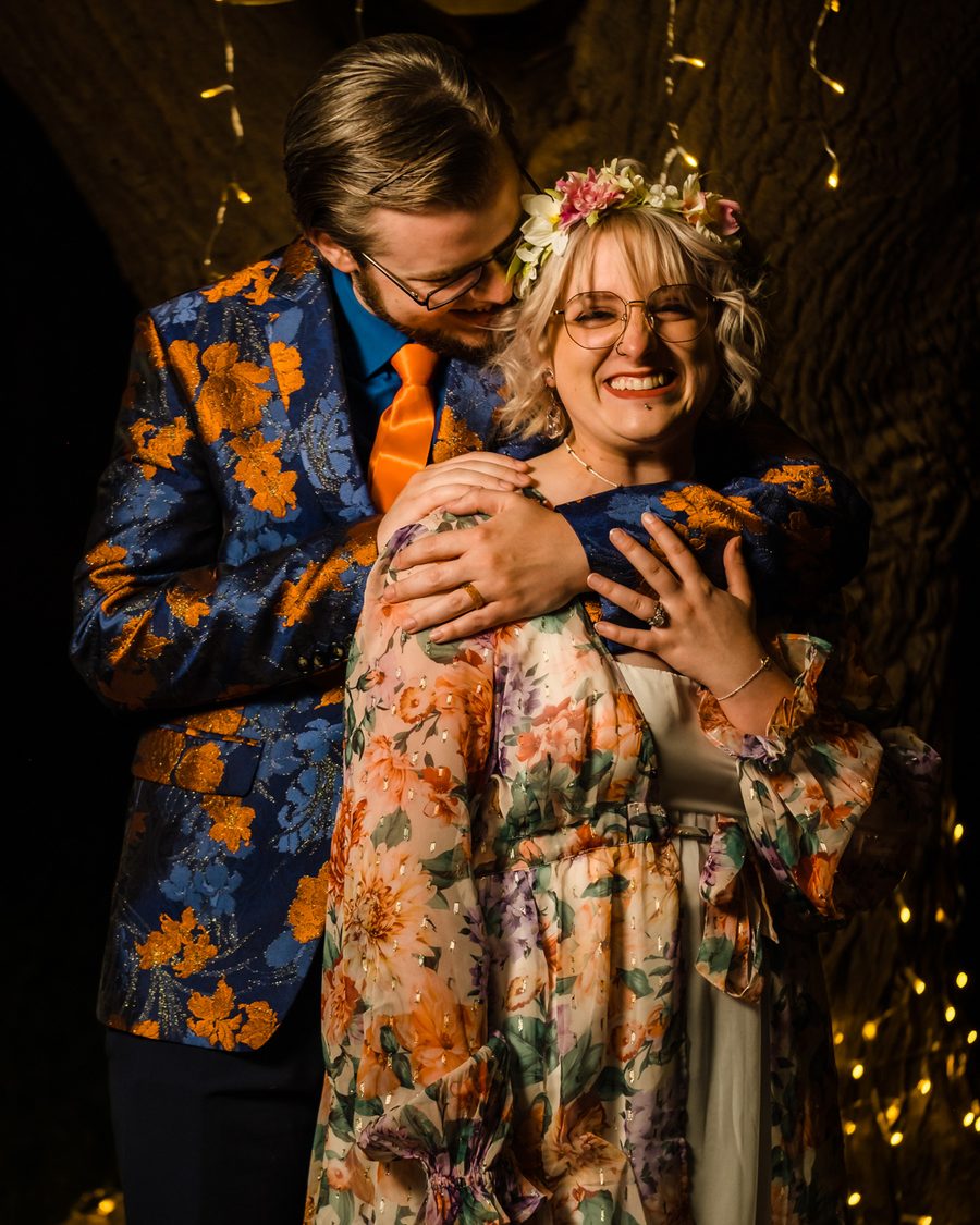 Couple embracing and laughing during their wedding reception